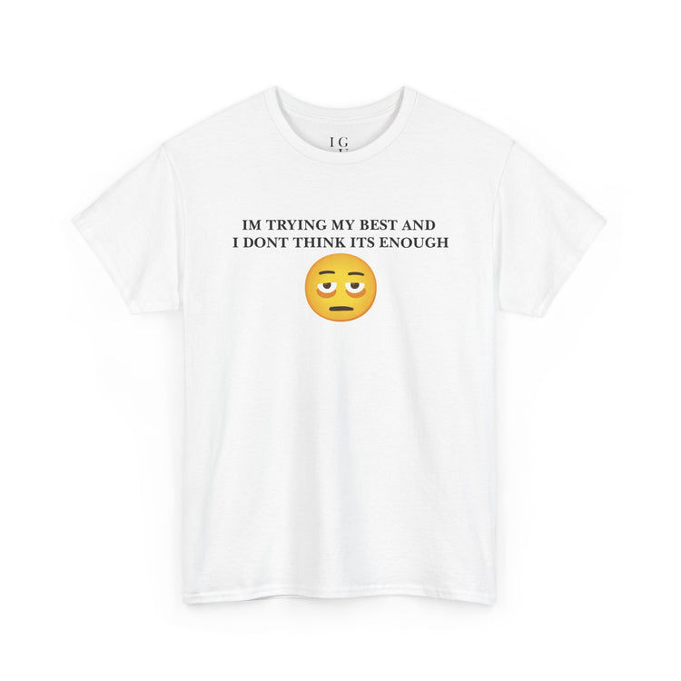 A white short-sleeve crewneck t-shirt with a graphic on the chest that reads 'IM TRYING MY BEST AND I DONT THINK ITS ENOUGH' in black text above a yellow sad emoji face.